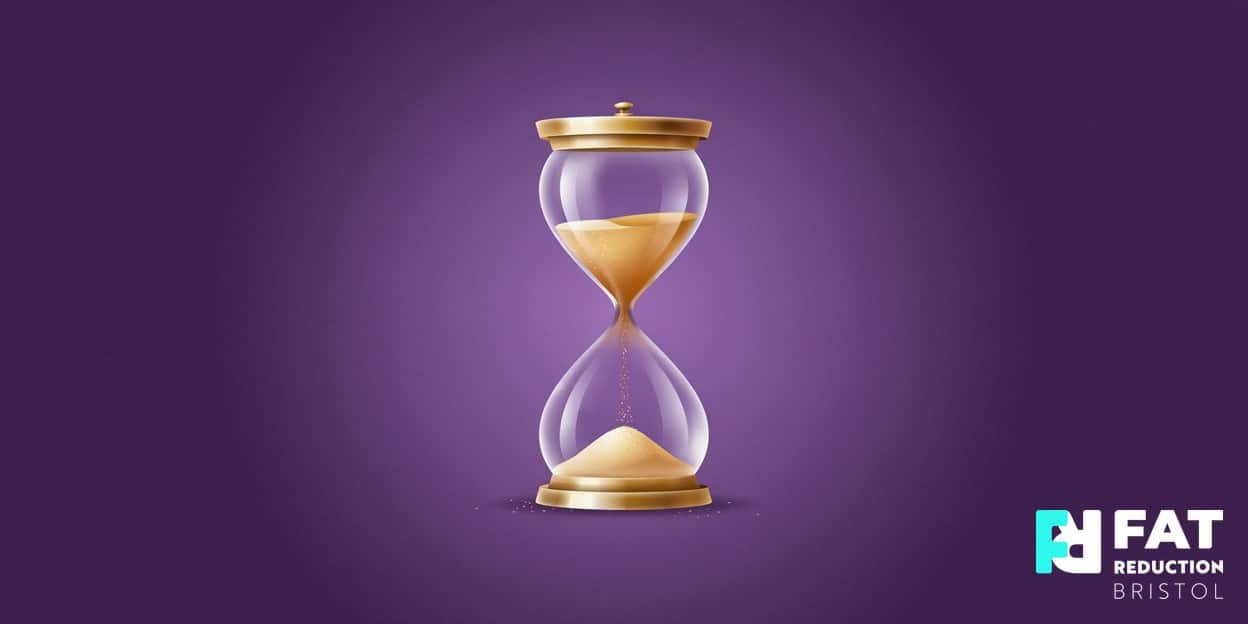 A flat-vector illustration of a single elegant golden hourglass with a soft inner glow, centred on a bold plum-purple background