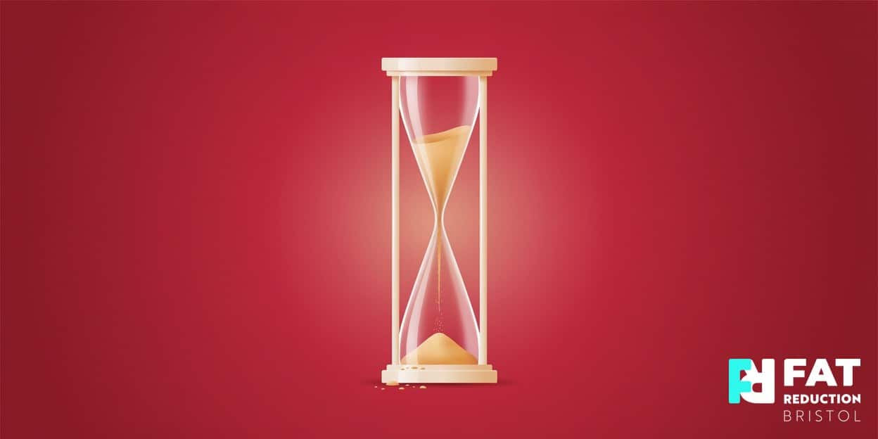 A flat-vector illustration of an hourglass with golden sand slipping downward, on a bold crimson background